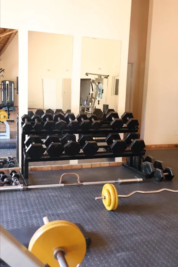 Dumbbell rack and barbells at Tunya Fit