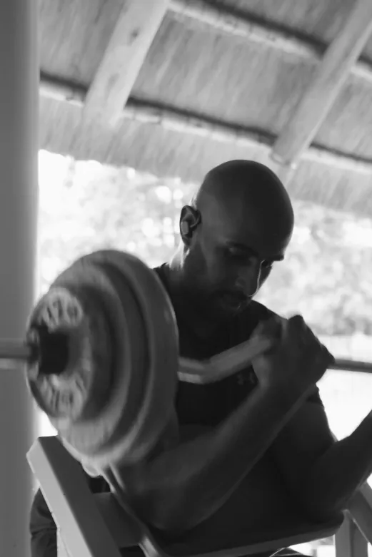 Member doing preacher curls at Tunya Fit